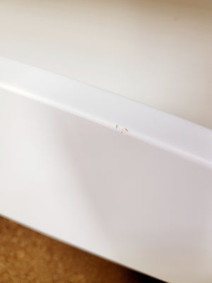 Close up of small flaw on the Rhianna twin bed in birch wood with white lacquer.