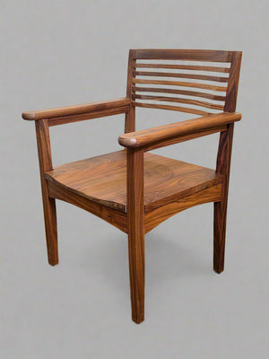Wooden chair against a white wall and brown textured wall.