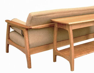 Linnaea Sofa Table shown behind Linnaea Sofa in Cherry made-to-order hardwood furniture using sustainable sourced hardwoods
