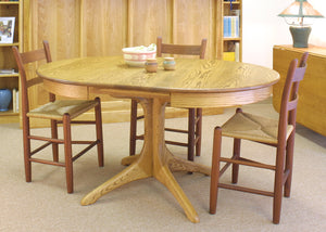 Walden Small Round Extension Table in Red Oak feature matching middle table extensions called leaves placed in the center gap